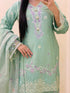 Light green embroidered traditional outfit with floral patterns on a beige background